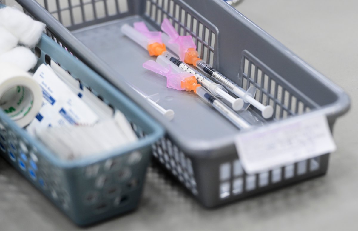 A basket of needles containing Pfizer-BioNtech COVID-19 vaccine waits to be administered to patients at a COVID-19 clinic in Ottawa on Tuesday, March 30, 2021.