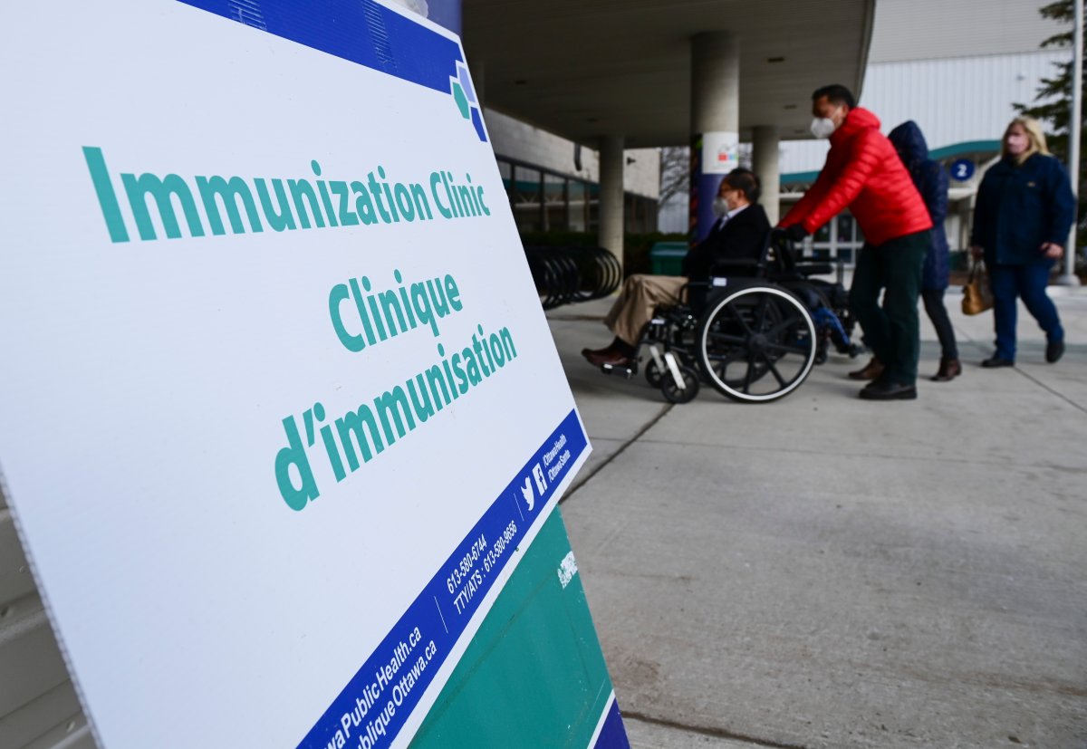 People arrive for their vaccine appointment time at a COVID-19 clinic in Ottawa on Tuesday, March 30, 2021. 