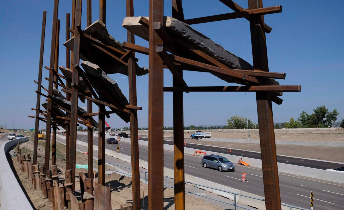 Traffic passes the sculpture called “Bowfort Towers,” by New York artist Del Geist, located near Canada Olympic Park in Calgary, Alta., Wednesday, Aug. 9, 2017.