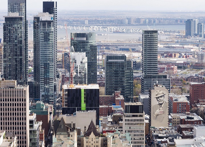A view of downtown Montreal shows a mural in honour of the late poet/songwriter Leonard Cohen.