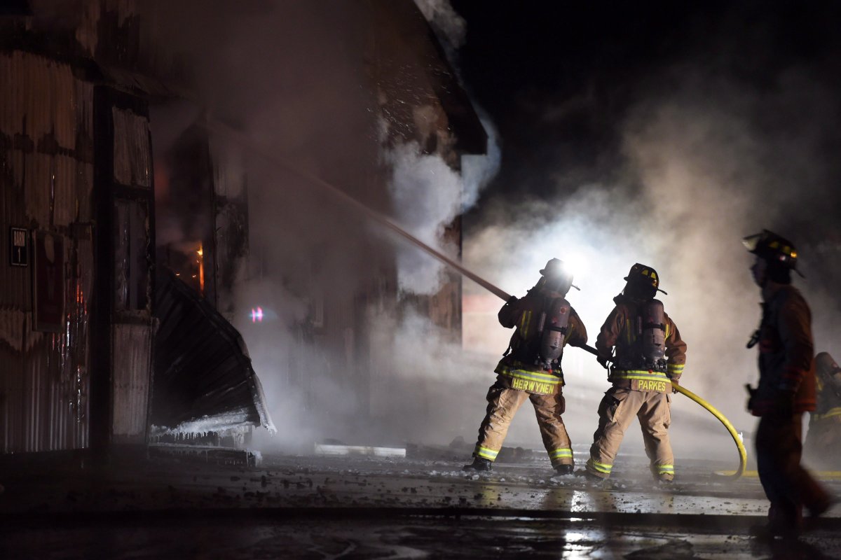 Firefighters work to bring a blaze under control at the Classy Lane Stables, in Puslinch, Ont., on January 5, 2015.