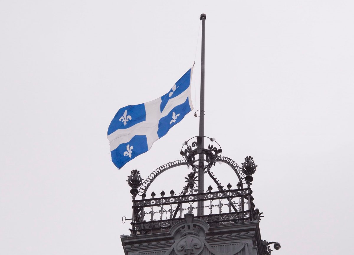 The Quebec flag flies at half-mast on the high tower of the national assembly. 