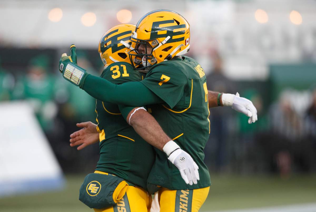 Edmonton Eskimos’ Calvin McCarty (31) and quarterback Trevor Harris (7) celebrate a touchdown against the Saskatchewan Roughriders during first half CFL action in Edmonton, Alta., on Saturday, Oct. 26, 2019.