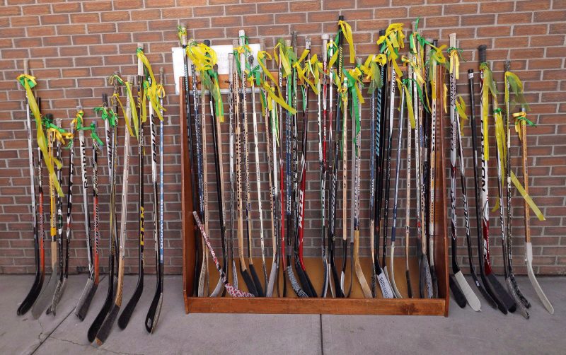 Hockey sticks stand outside the front door of a funeral service for Humboldt Broncos' Logan Boulet at the Nicholas Sheran Arena in Lethbridge, Alta. on Saturday, April 14, 2018. 
