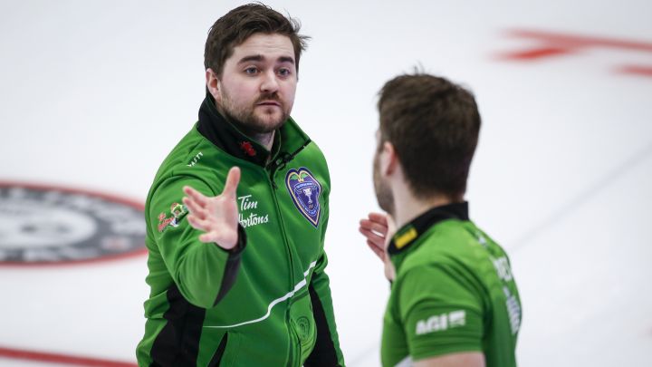 Team Saskatchewan skip Matt Dunstone, left, celebrates with second Kirk Muyres after defeating Team Quebec at the Brier in Calgary, Alta., Tuesday, March 9, 2021.