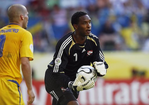 Dortmund, Germany — Trinidad and Tobago’s goalkeeper, Shaka Hislop, holds the ball next to Swedish midfielder Freddie Ljungberg (L) during the 2006 World Cup group B football game Trinidad and Tobago vs. Sweden, June 10, 2006, at Dortmund stadium. (ARIS MESSINIS/AFP via Getty Images)