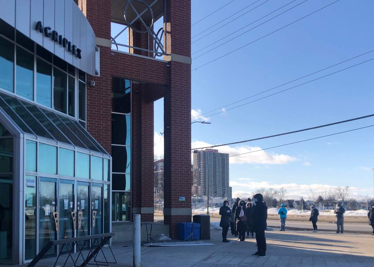 People lined up outside the Western Fair Agriplex waiting to get a their COVID-19 vaccine. 