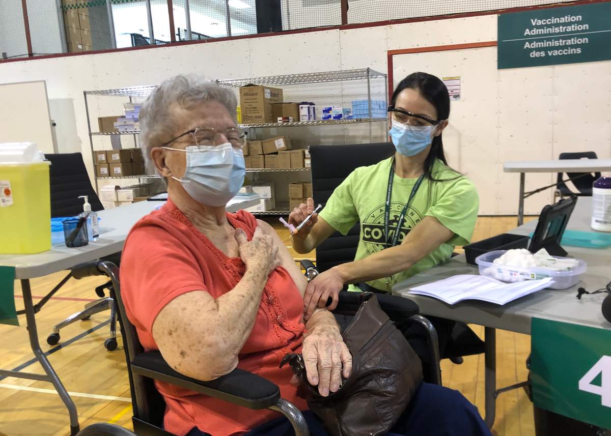 Shirley Banks, 88, receives the first dose during the opening of the North London Optimist Community Centre COVID-19 vaccine clinic on March 17, 2021.