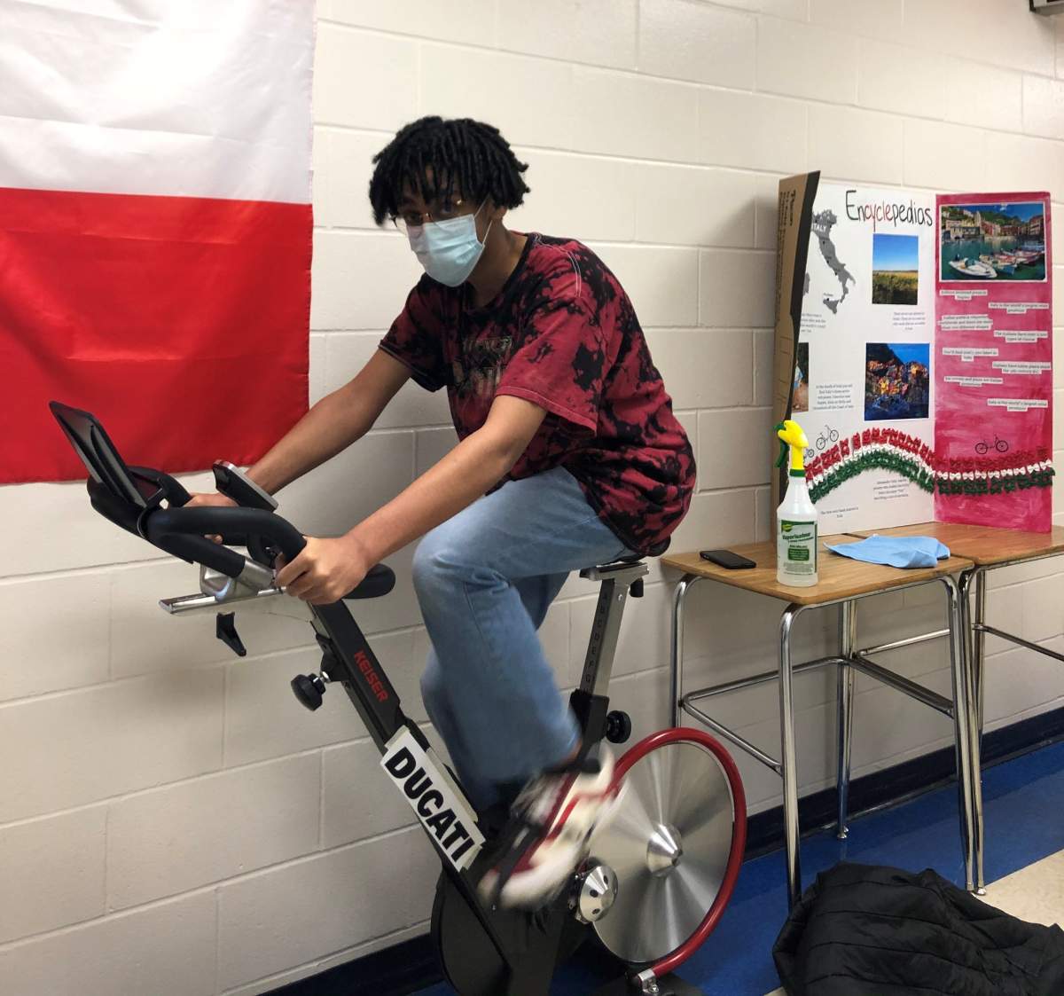 A student on a bike at St. Francis Xavier High School