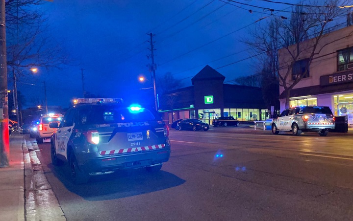 Officers respond to a bank on Lake Shore Boulevard West Friday evening.