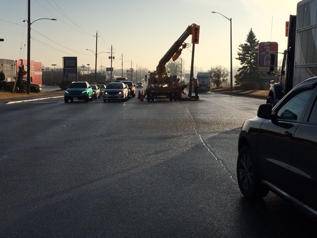Crews repair a traffic light at Lansdowne Street and Monaghan Road following a crash on Thursday morning.