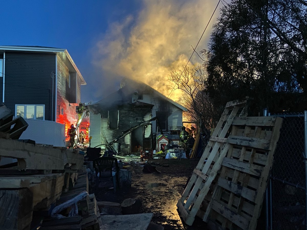 Fire crews battle a house fire in the area of 133 Avenue and 104 Street in Edmonton's Rosslyn neighbourhood Thursday, March 18, 2021.