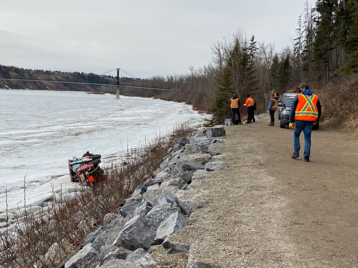 The driver of a street sweeper was rescued after tipping onto the banks of the North Saskatchewan River in Edmonton Wednesday, March 31, 2021.