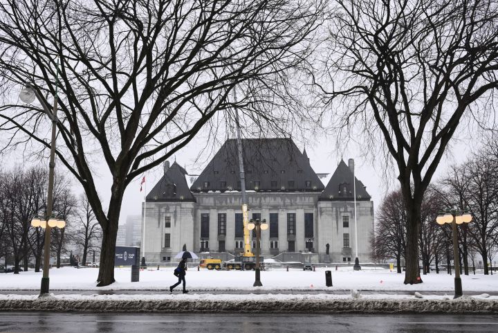 A pedestrian walks past the Supreme Court of Canada in Ottawa on Thursday, Nov. 26, 2020. 