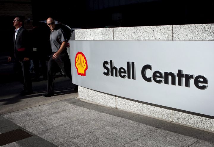 Pedestrians walk past Shell Canada's headquarters before the company announces a new commercial sized oil sands tailings project during a news conference in Calgary, Thursday, Aug. 26, 2010.