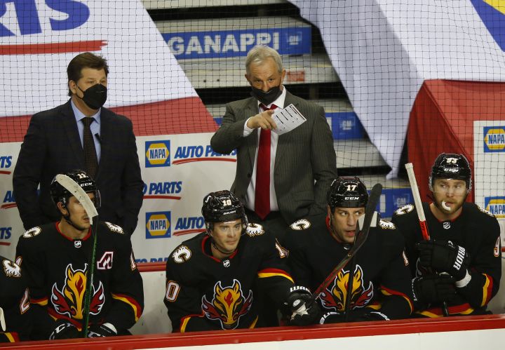 New Calgary Flames head coach Darryl Sutter gives out instructions during the first period of their NHL hockey game against the Montreal Canadiens in Calgary, Thursday, March 11, 2021.