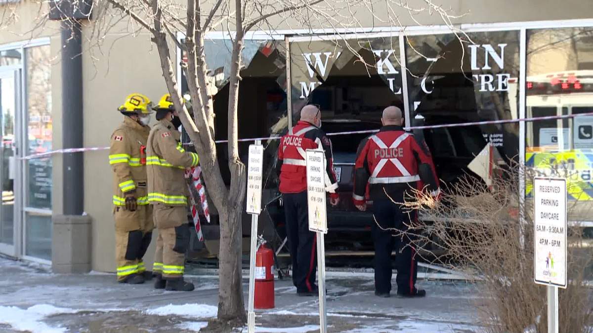 First responders assess damage after a vehicle drove through the wall of a medical clinic in Calgary on Tuesday.