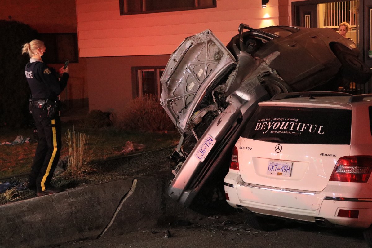 A crashed car ended up on top of another vehicle in a Kelowna driveway early Sunday morning. 