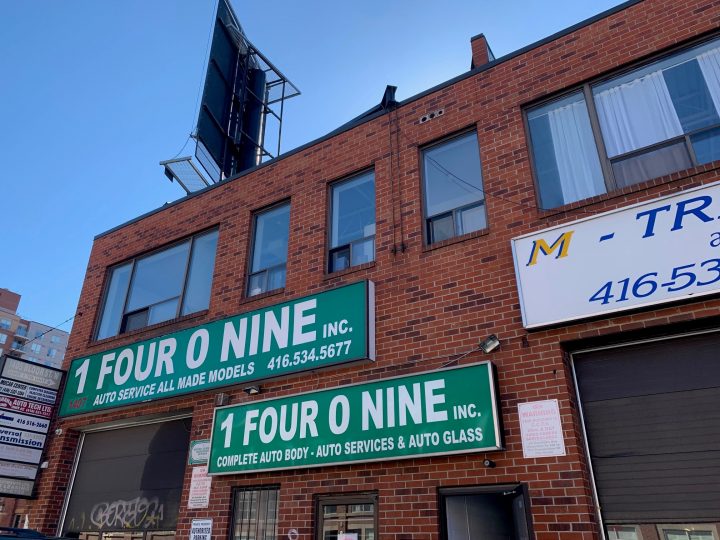 The apartments are located above an auto body shop on Bloor Street West, just east of Dundas Street West. 