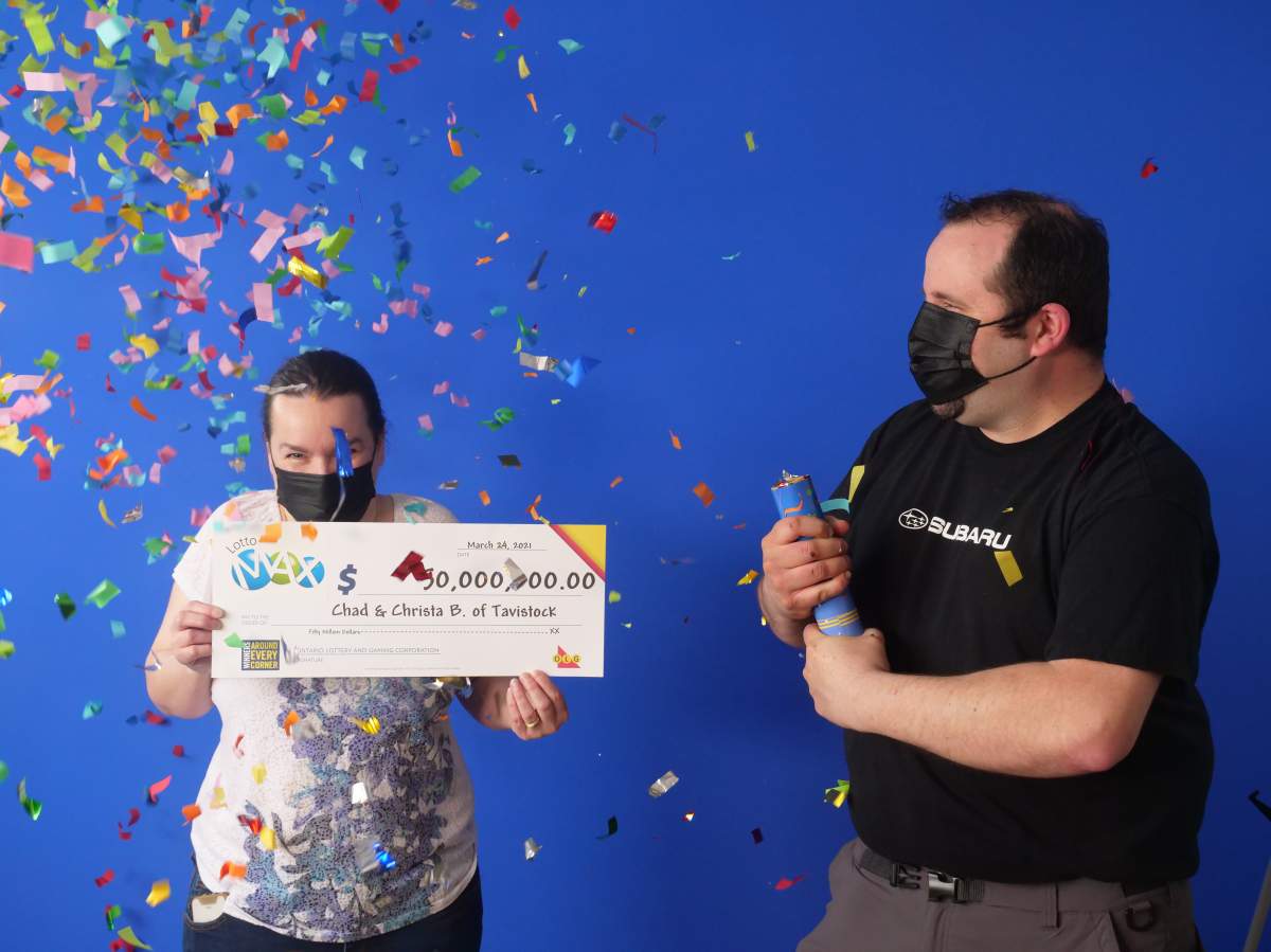 Christa and Chad Breyer celebrate while picking up their newfound fortune.