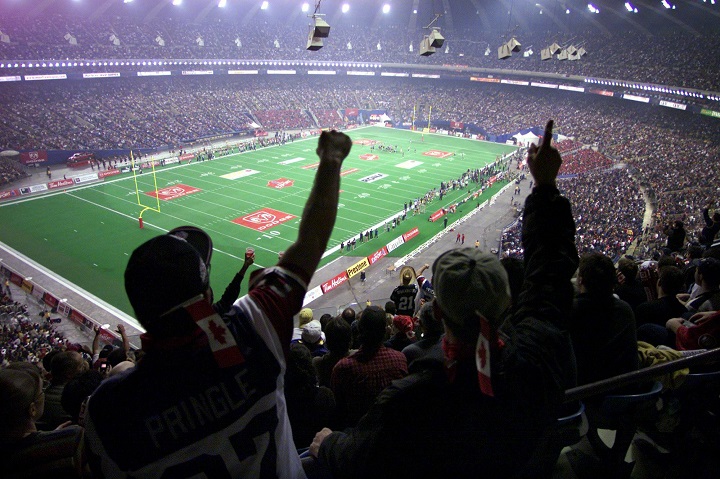 FIn this file photo, football fans cheer at the start of the 89th Grey Cup at the Olympic Stadium in Montreal.