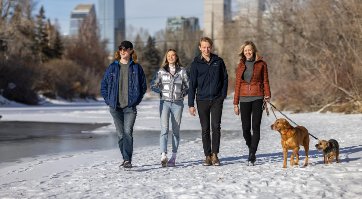 Karen Gosbee (R) and her family walking through a Calgary neighbourhood.