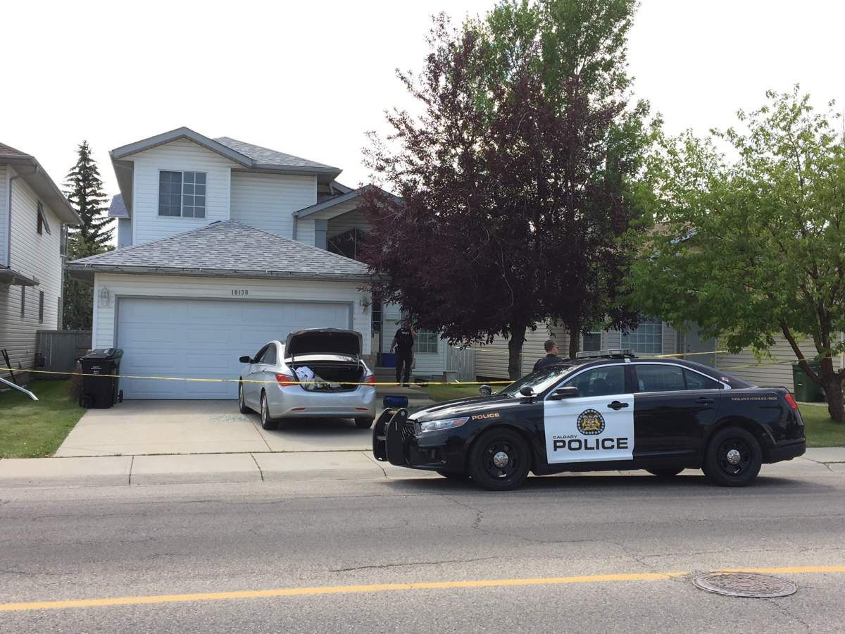 Calgary police at the scene of a home in Hidden Valley where two people were found dead on Tuesday, July 31.