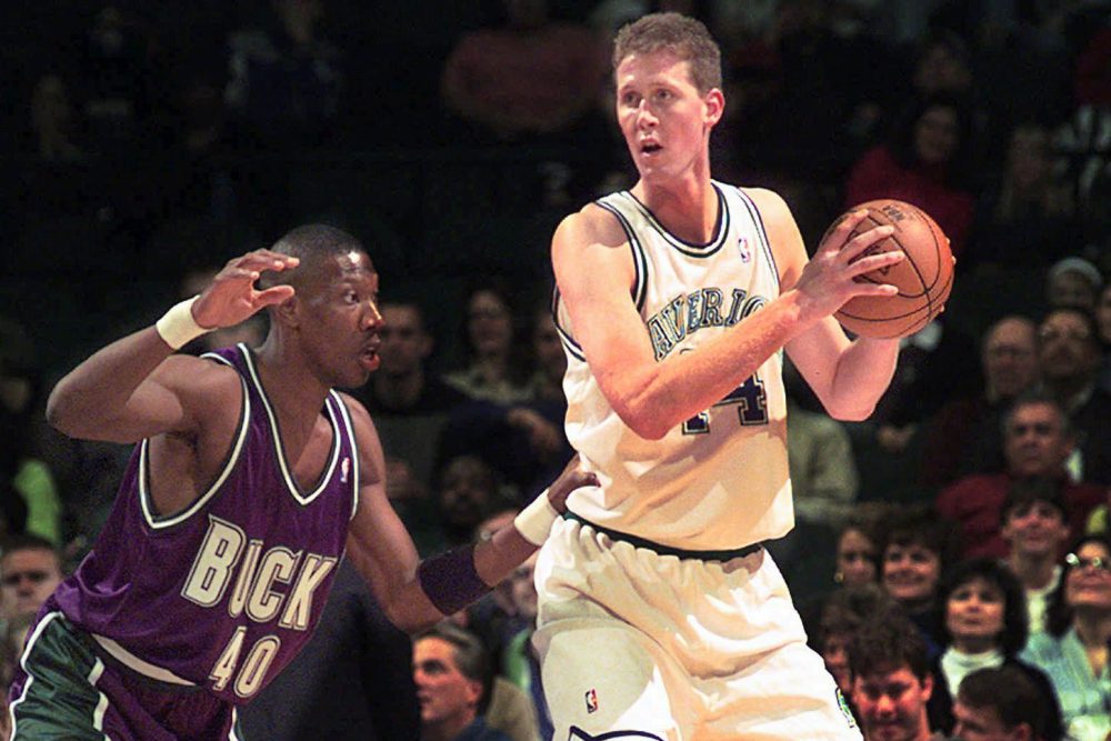 In this Nov. 22, 1997, file photo, Dallas Mavericks' Shawn Bradley (44) looks to pass as Milwaukee Bucks' Ervin Johnson (40) defends during the first quarter of an NBA basketball game at the Reunion Arena in Dallas. 
