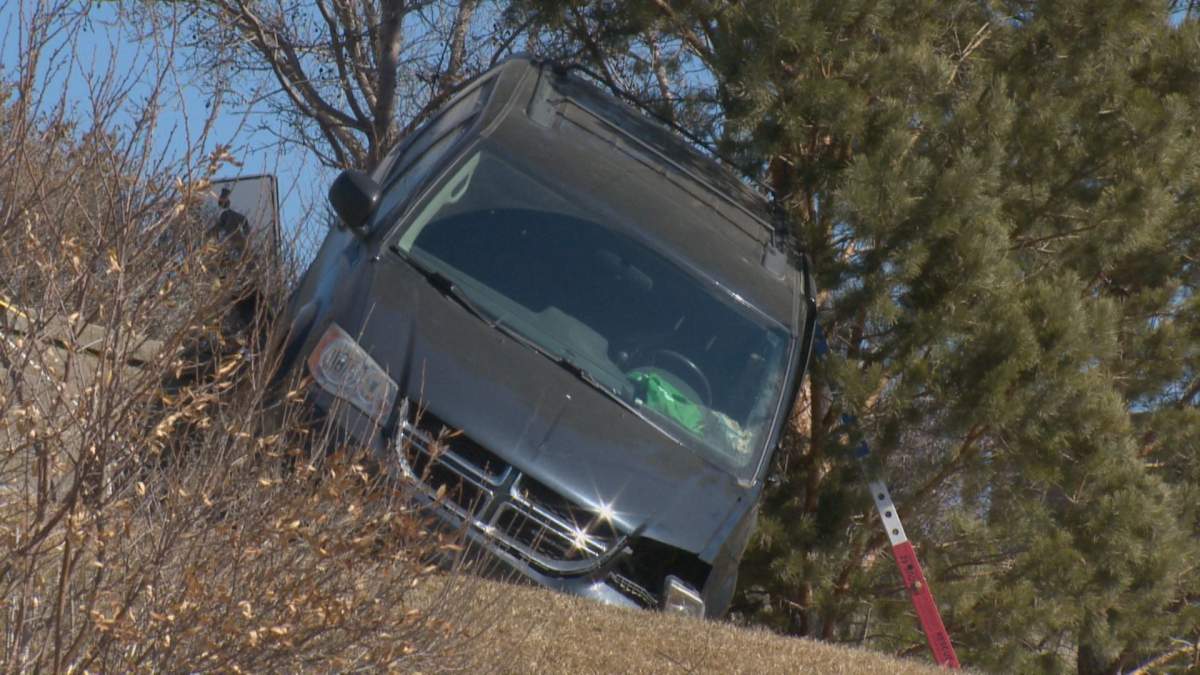 A walking trail is blocked near Saskatoon's River Landing area while crews work to remove a damaged minivan from the area.