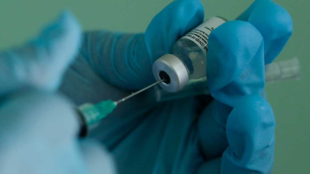 A nurse prepares a dose of the Pfizer COVID-19 vaccine.