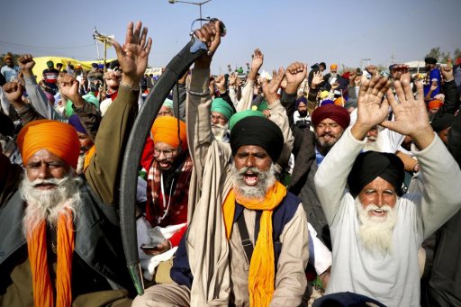 In this Dec. 14, 2020, file photo, protesting farmer leaders shout slogans as they sit on a day long hunger strike at the Delhi- Haryana border, outskirts of New Delhi.