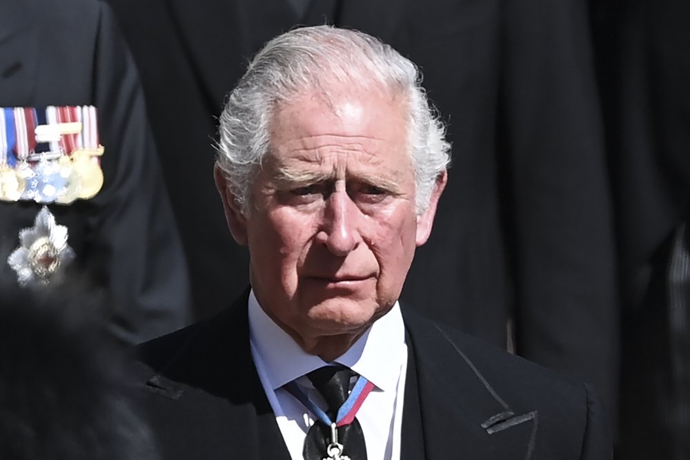 Britain's Prince Charles sheds a tear as he follows the coffin as it makes it's way past the Round Tower during the funeral of Britain's Prince Philip inside Windsor Castle in Windsor, England Saturday April 17, 2021. 