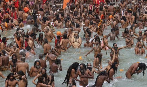 In this April 12, 2021, file photo, devotees take holy dips in the Ganges River during Kumbh Mela, or pitcher festival, one of the most sacred pilgrimages in Hinduism, in Haridwar, northern state of Uttarakhand, India.