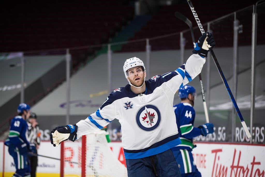 The Winnipeg Jets’ Adam Lowry celebrates his second goal during the third period of a 2021 NHL hockey game against the Vancouver Canucks in Vancouver. THE CANADIAN PRESS/Darryl Dyck