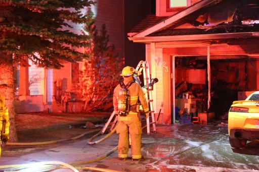 Calgary firefighters respond to a blaze at a home along Mt. Selkirk Close Southeast on Friday.