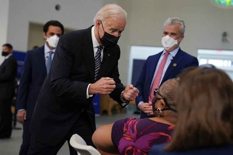 President Joe Biden talks to a person receiving a COVID-19 vaccination shot as he visits a vaccination site at Virginia Theological Seminary, Tuesday, April 6, 2021, in Alexandria, Va. 
