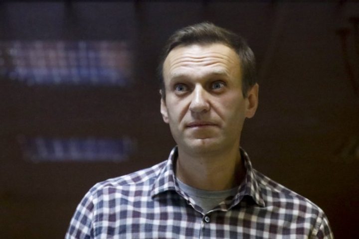 FILE - In this Saturday, Feb. 20, 2021 file photo, Russian opposition leader Alexei Navalny stands in a cage in the Babuskinsky District Court in Moscow, Russia. A doctor for imprisoned Russian opposition leader Alexei Navalny, who is in the third week of a hunger strike, said on Saturday April 17, 2021, his health is deteriorating rapidly and the 44-year-old Kremlin critic could be on the verge of death. 