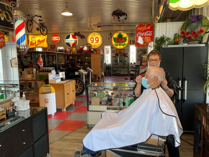 Dee Green cuts Barry Warnica's hair on Wednesday at the Call of the West Museum in High River.