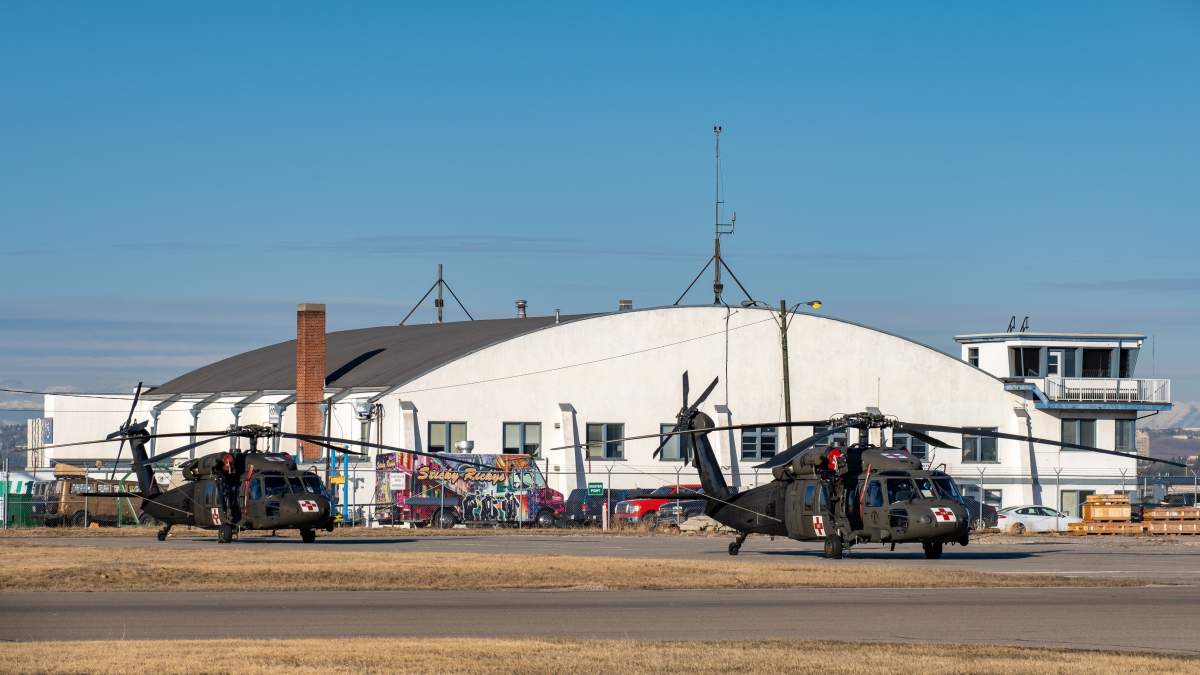 Two U.S. Army National Guard UH-60 Black Hawk helicopters at the Calgary International Airport on April 15, 2021.