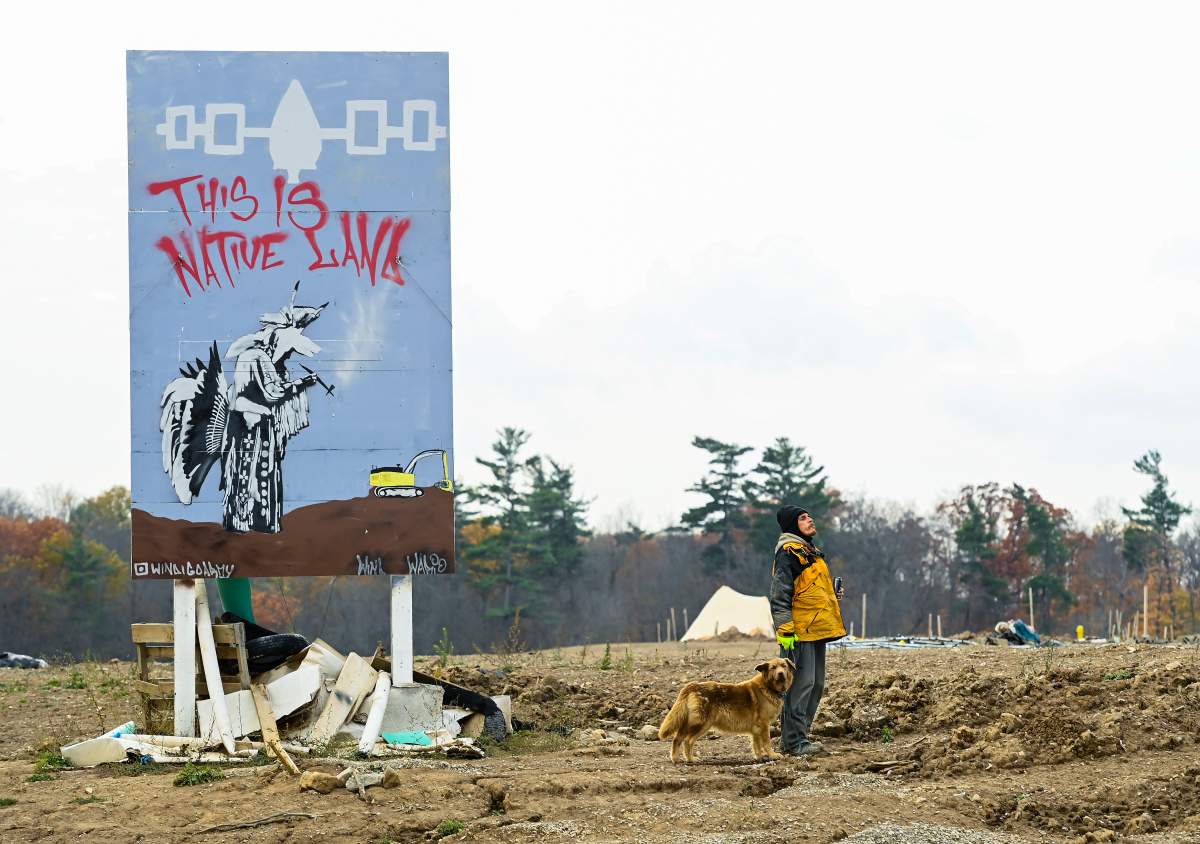 An Indigenous Mohawk called Wack camps out at a construction site at the centre of an Indigenous land dispute in Caledonia, Ont., on Thursday, October 29, 2020. THE CANADIAN PRESS/Nathan Denette.