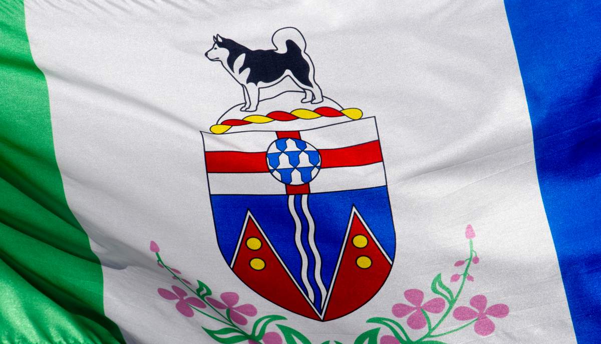 The Yukon provincial flag flies on a flag pole in Ottawa,  Monday July 6, 2020. Yukon public health officials say they are investigating the source of the origin of a COVID-19 outbreak in the small community of Watson Lake. THE CANADIAN PRESS/Adrian Wyld.