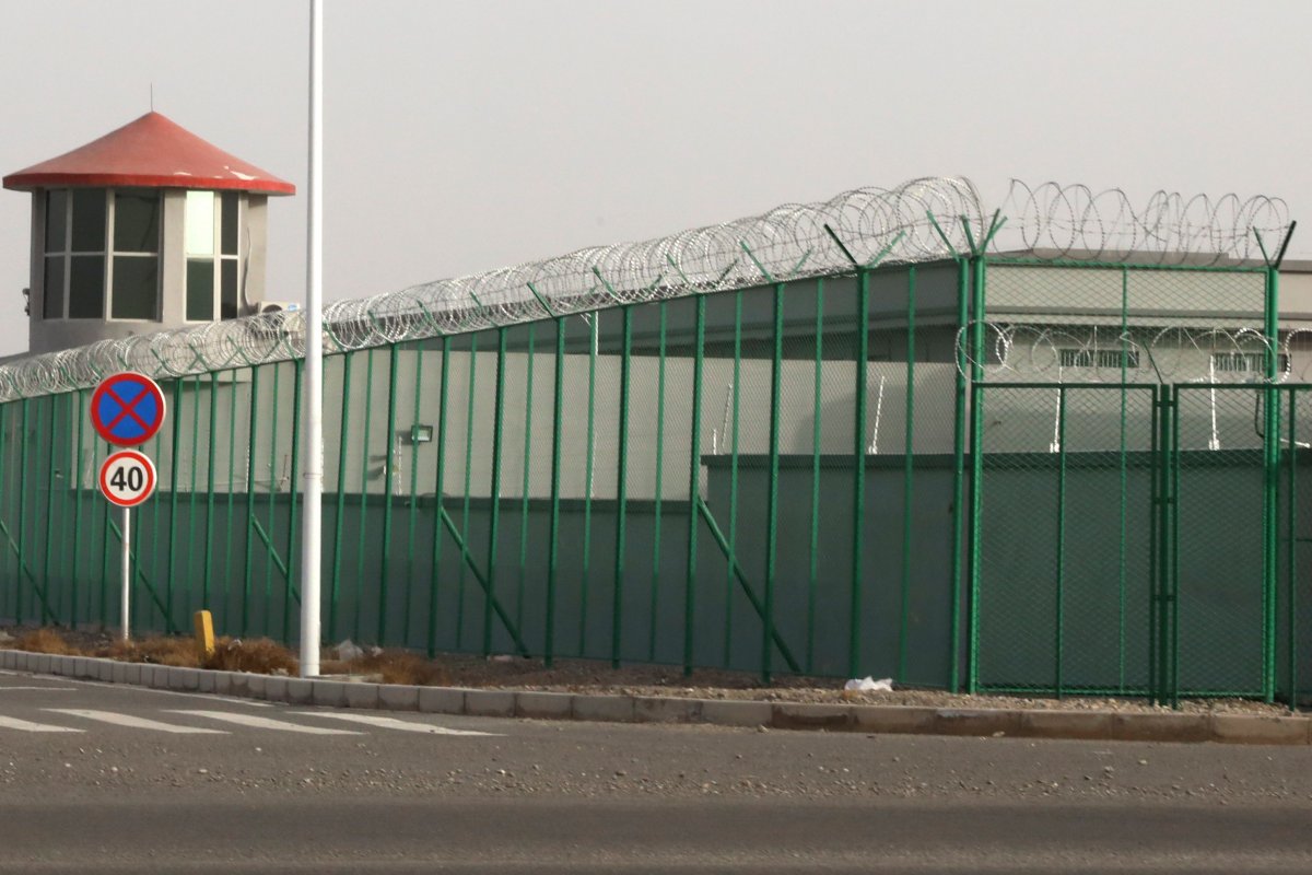 FILE - In this Monday, Dec. 3, 2018, file photo, a guard tower and barbed wire fence surround a detention facility in the Kunshan Industrial Park in Artux in western China's Xinjiang region.