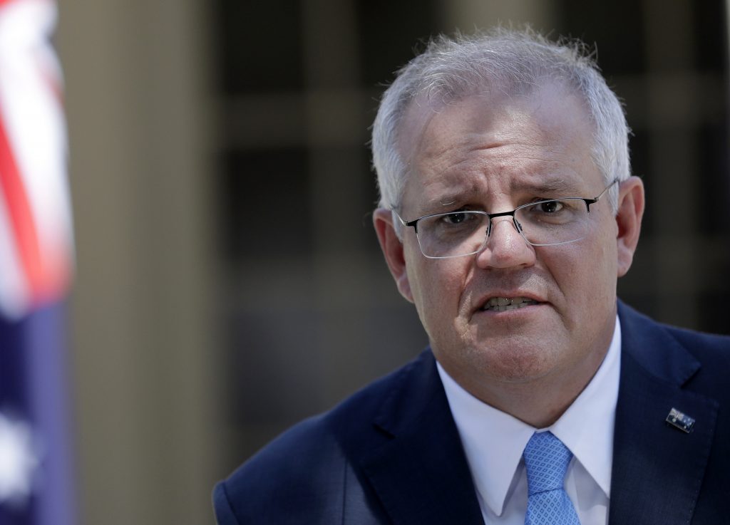 Australia's Prime Minister Scott Morrison speaks to the media in Sydney, Monday, March 1, 2021. Morrison stood by an unnamed Cabinet minister against calls for him to step down from office over an allegation that he raped a 16-year-old girl more than 30 years ago. (AP Photo/Rick Rycroft).