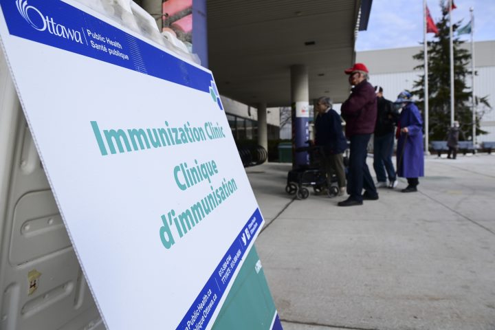 People arrive for their vaccine appointment time at a COVID-19 vaccination clinic in Ottawa on Tuesday, March 30, 2021.