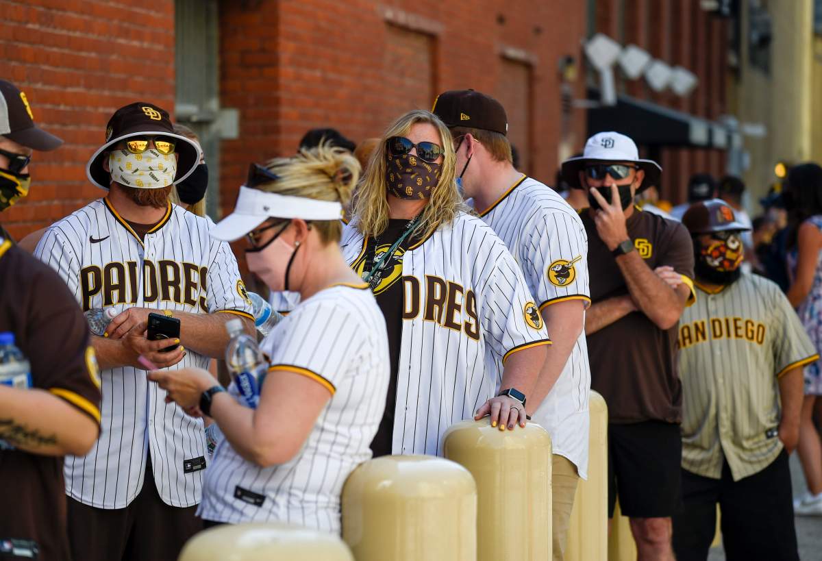 Baseball fans wait in line before the gates opened up before a baseball game between the Arizona Diamondbacks and the San Diego Padres Thursday, April 1, 2021, on opening day in San Diego.