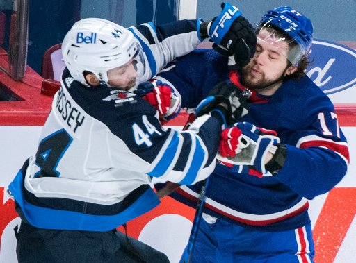 Montreal Canadiens’ Josh Anderson (17) collides with Winnipeg Jets’ Josh Morrissey during first period NHL hockey action in Montreal, Saturday, April 10, 2021.