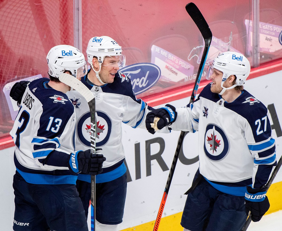 Winnipeg Jets' Paul Stastny (25) celebrates his goal with teammates Pierre-Luc Dubois (13) and Nikolaj Ehlers (27) during second period NHL hockey action against the Montreal Canadiens, in Montreal, Saturday, April 10, 2021.