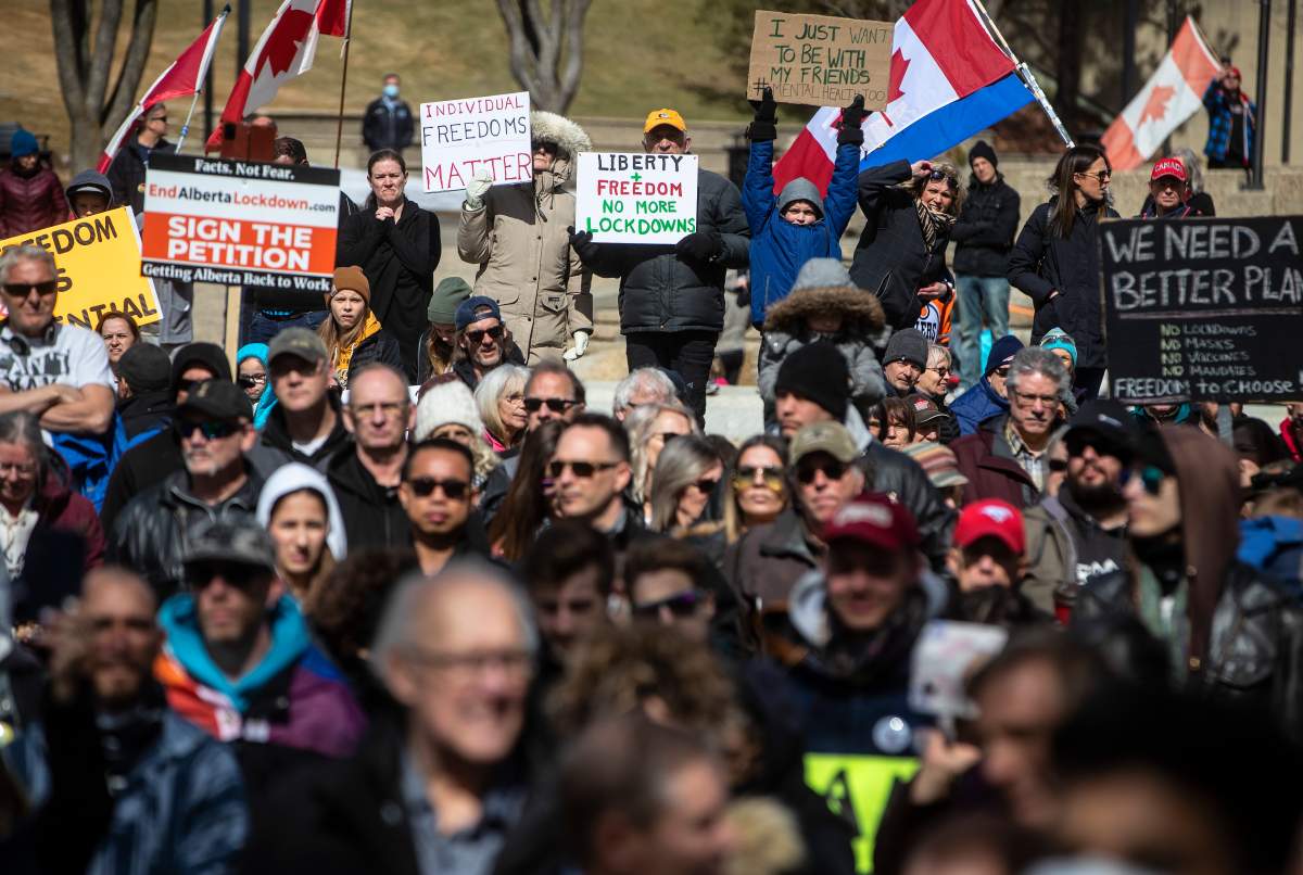 Anti-lockdown and anti-mask protesters take part in a rally outside the Alberta Legislature in Edmonton on Monday, April 12, 2021.