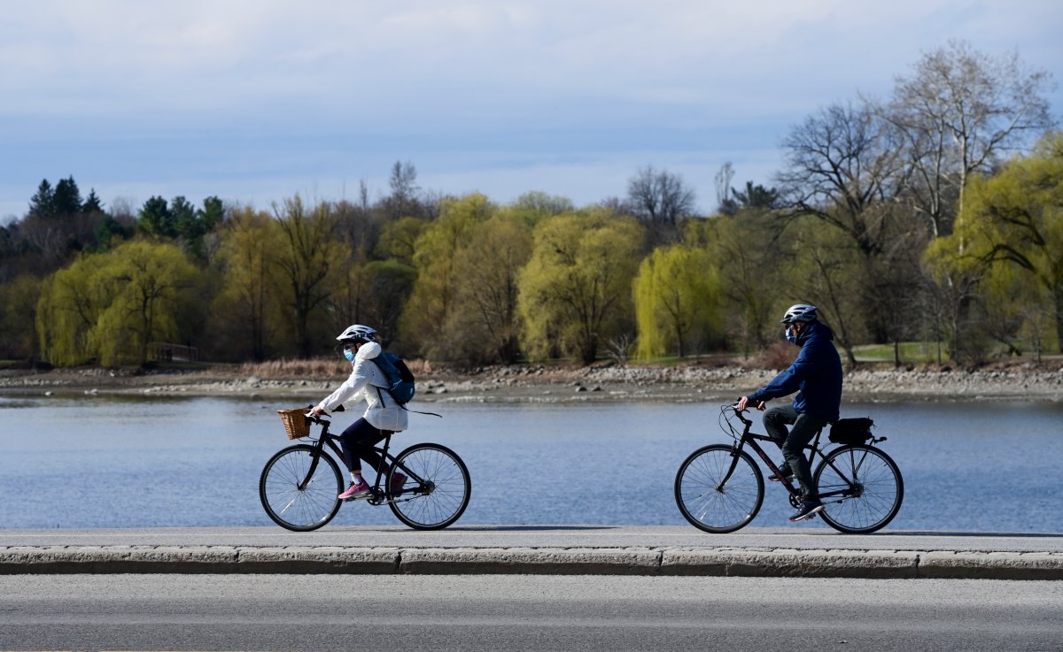 Masked cyclists make their way along the edge of Dow's Lake as the third wave of the COVID-19 pandemic grips Ottawa on Tuesday, April 13, 2021. 