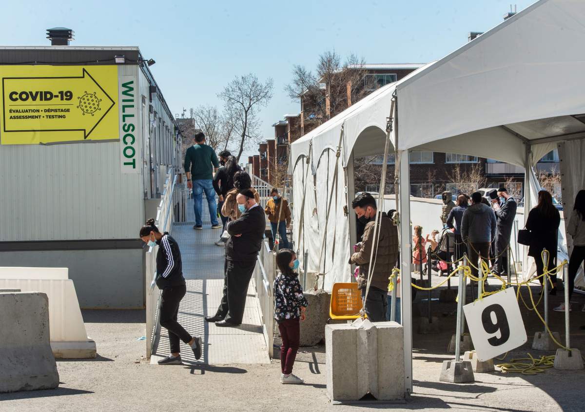 People line up at a COVID-19 testing clinic, Tuesday, April 13, 2021  in Montreal.